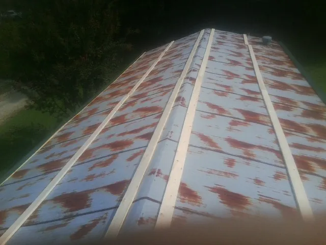 Rusted metal roof panels with new wood purlins before replacement — Storm Damage Roof Repair in Philomath by Roofing Brothers